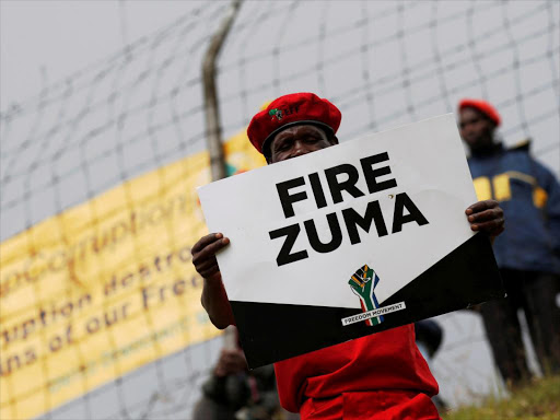 Supporters of various opposition parties hold placards calling for the removal of President Jacob Zuma outside the Constitutional Court in Johannesburg, South Africa, May 15, 2017. /REUTERS