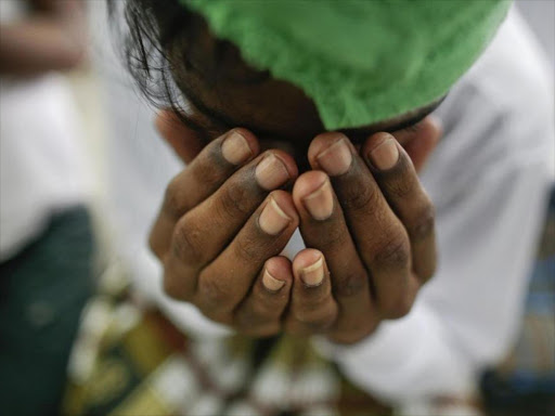 A suspected victim of human trafficking prays at a government shelter in Takua Pa district of Phang Nga October 17, 2014. Photo/REUTERS