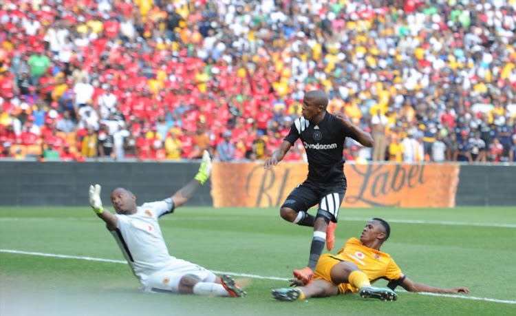 Luvuyo Memela of Orlando Pirates scoring his goal past Itumeleng Khune and Siyabonga Ngezana of Kaizer Chiefs during the Absa Premiership match between at FNB Stadium on March 03, 2018.