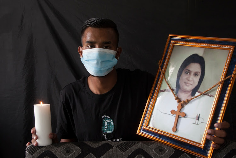 Owen Govender lights a candle for his late mom, Vanessa Govender, a front-line worker at Chatsworth's RK Khan hospital who died after a Covid-19 related illness.