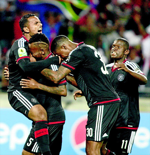 TRIUMPHANT: Orlando Pirates' Kermit Erasmus, left, and teammates congratulate Mpho Makola (5) afer scoring the first goal of their CAF Confed Cup against AC Leopards on Saturday PHOTO: ANTONIO MUCHAVE