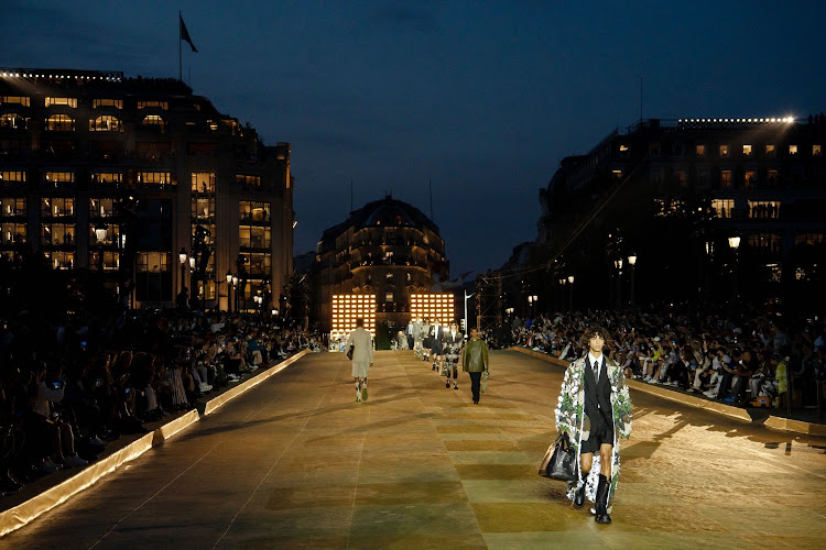 Models on the runway during the Louis Vuitton Spring-Summer 2024 Men's collection show at Pont Neuf bridge in Paris.