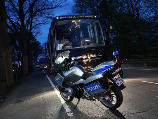 A Police motorcylce with the Borussia Dortmund team bus after an explosion near their hotel before the game, April 11, 2017. /REUTERS