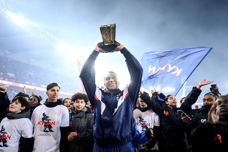 Kylian Mbappé celebrates with a trophy during a ceremony for him becoming Paris-St Germain's all time top corer with 201 goals after scoring in their Ligue 1 match against Nantes at Parc des Princes in Paris on March 4 2023 .