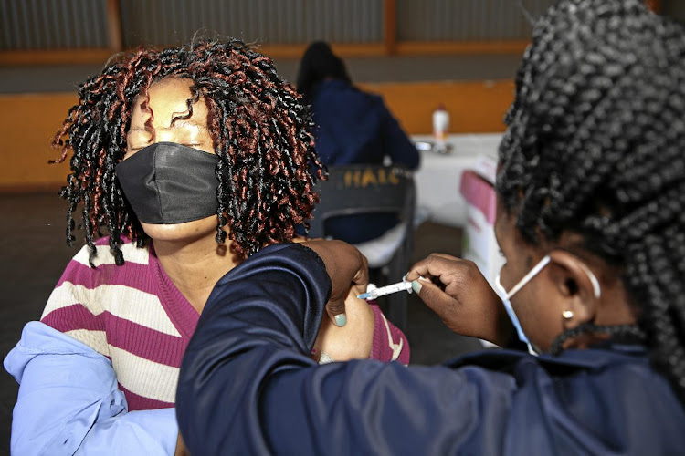 A woman receives the Covid-19 vaccine at a Meadowlands vaccination site in Soweto on Wednesday after the health department opened vaccine registration (vaccine.enroll.health.gov.za/) to people aged 35 years and above.