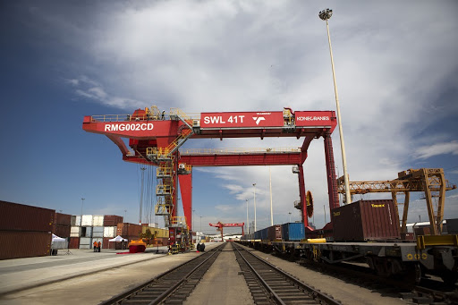 A loading crane straddles a freight rail track at a Transnet’s container handling terminal. Picture: BLOOMBERG