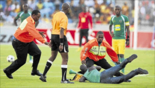 NOT WANTED: Scenes like these during a football match between Kaizer Chiefs and Lamontville Golden Arrows when a spectator attacked a referee won't be tolerated Photo: THEMBINKOSI DWAYISA