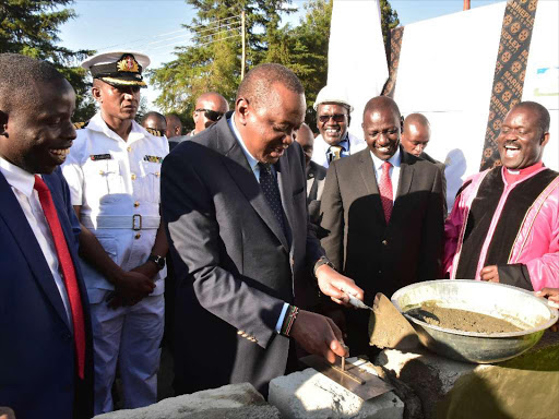 President Uhuru Kenyatta and DP William Ruto lay a foundation stone for AIC Kapsabet. /PSCU