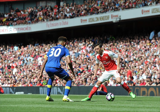 Mesut Ozil of Arsenal takes on Mason Holgate of Everton during the Premier League match between Arsenal and Everton at Emirates Stadium on May 21, 2017 in London, England. (Photo by David Price/Arsenal FC via Getty Images)