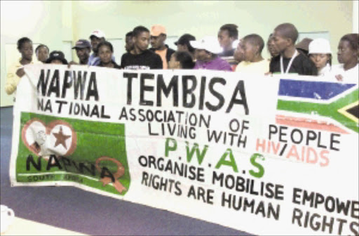 SW20040825LKU010:NEWS:GENERIC:25AUG2004 - 20040825LKU: NEWS: Members of the Tembisa branch of National Association of People Living with HIV/AIDS(NAPWA) staged a sit-in at the organisation's national office in Germiston, Ekurhuleni demanding funds for the programme. Pic. LEN KUMALO. 25/08/2004. © Sowetan.