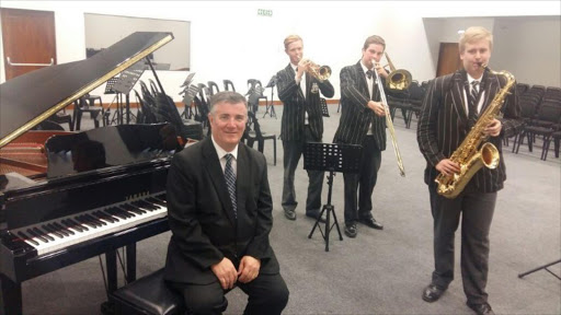 HIGH NOTE: Selborne College musical director Willam Paxton with matric musicians (from left) Jordan Blundell, Hugo Smit and Mark Lynch in the auditorium of the school's sophisticated new music centre which officially opens tomorrow evening. Picture: BARBARA HOLLANDS