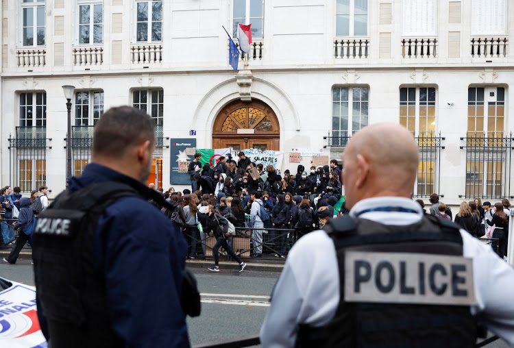 French police stand guard as students block the entrance of the Lycee Montaigne high school to protest as part of a nationwide day of strike in Paris,. Picture: Reuters/Gonzalo Fuentes