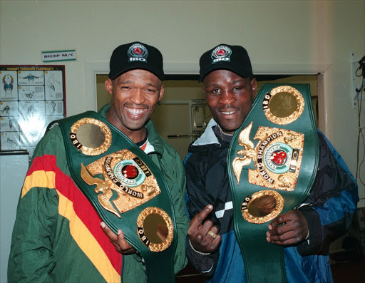 Mpush Makambi IBO middleweight champion with Peter Malinga welterweight IBO champion here they brandish their belts after Makambi successfully defended his crown while Malinga won a vacant title in Coventry in London on 23 October 1999. Pic by Mxolisi Ntshuca