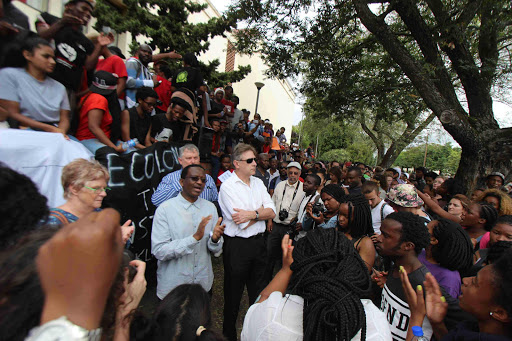 HELPING HANDS: Rhodes University vice-chancellor Dr Sizwe Mabizela, left, addresses students during protests over high fees Picture: DAVID MACGREGOR