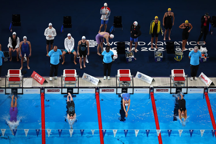 Swimmers compete in the women's 4x100m medley relay heats in Doha on Sunday.