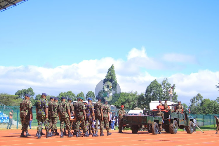 Senior military officers behind the military gun carrier that will be used the carry the remains of late General Francis Ogolla at Ulinzi sports complex on April 20, 2024.