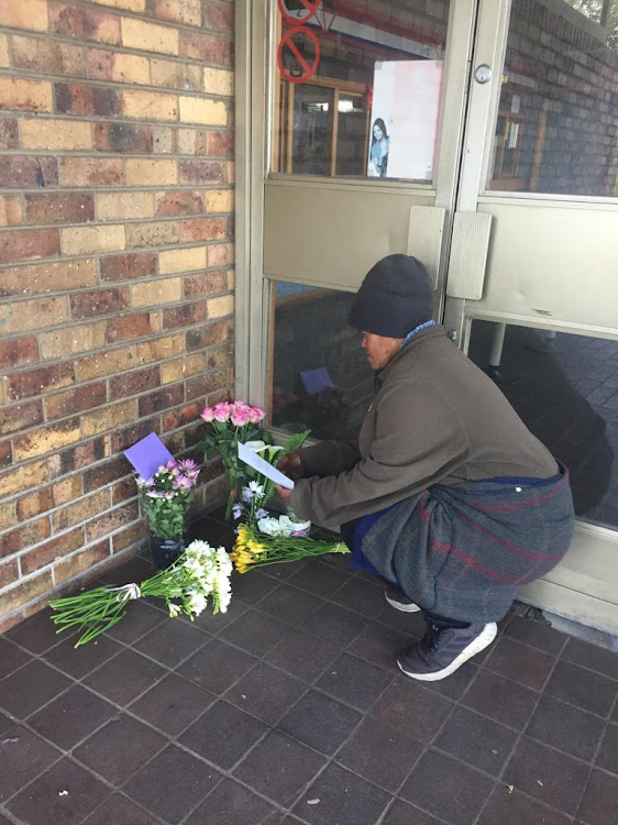 Following a man's court appearance, messages of shock and support have been pouring in for slain UCT student Uyinene Mrwetyana. A woman reads a card left with a bunch of flowers outside Clareinch Post Office today.