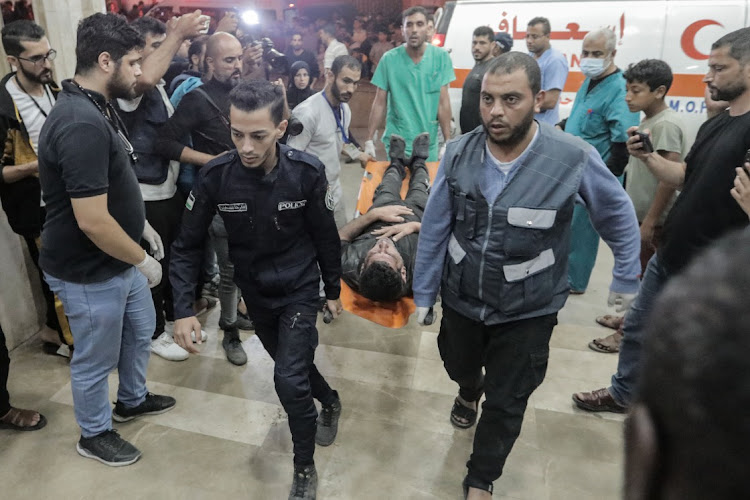 Palestinians carry an injured man into Nasser Medical Hospital in Khan Yunis, Gaza, November 14 2023. Picture: REUTERS