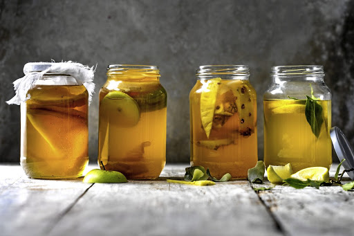 Kombucha comes in many different flavours including, from left, plain, apple, pineapple, and lemon and bay.