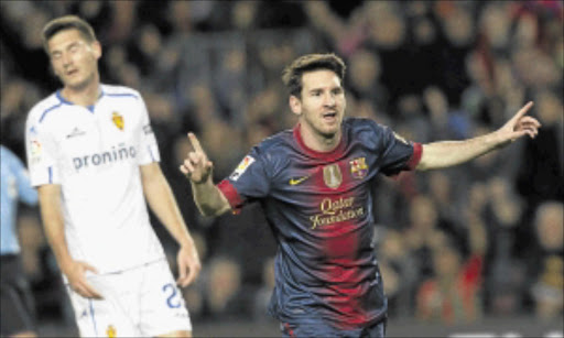 ON THE DOUBLE : Barcelona's Lionel Messi celebrates a goal against Zaragoza. pHOTO: REUTERS