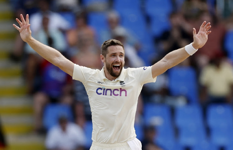 England's Chris Woakes celebrates after taking the wicket of West Indies' Jermaine Blackwood.
