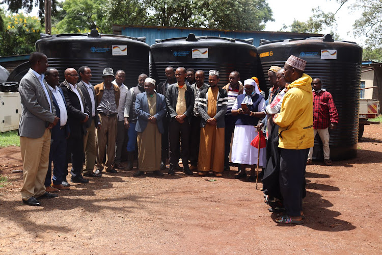 CECM water, environment and natural resource Malicha Boru joined by chief officer Rob Galma and two directors umuro Sharamo and Shakhe Stephen Katelo on Thursday during distribution of plastic water tanks to more than 20 groups across the county.