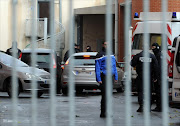 Police vehicles, reported to be bringing two alleged accomplices of gunman Mohamed Merah for questioning, arrive on December 4, 2012 at Toulouse's police station. French police arrested two alleged accomplices of gunman Mohamed Merah, whose Al-Qaeda-inspired shooting spree in and around the southern city of Toulouse left seven people dead.