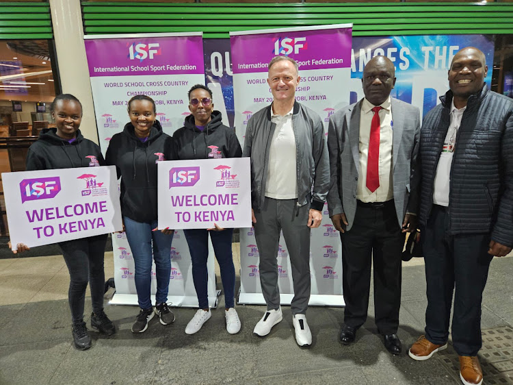 International School Sport Federation (ISF) president Laurent Petrynka (C) is welcomed on arrival at JKIA on Tuesday night