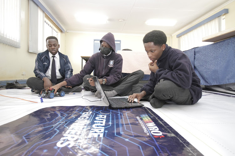 Makini Cambridge School participants Samuel Gordon, Leroy Shawn and Ian Waiguru prepare their Arduino kit for the competition