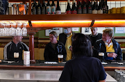 Customers chat over beers at the Fortune of War pub, on the first morning of pubs and many other businesses re-opening to vaccinated people, following months of lockdown orders to curb an outbreak of the coronavirus disease, in Sydney, Australia, on October 11 2021.