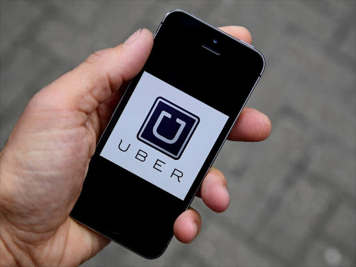 A photo illustration shows the Uber app logo displayed on a mobile telephone, as it is held up for a posed photograph in central London, Britain October 28, 2016. /REUTERS