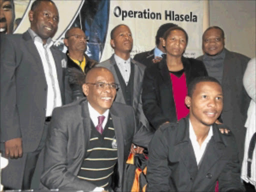 PROUD MOMENT: Free State premier Ace Magashule (front, left) with acting health MEC Msebenzi Zwane (back, left), Mangaung municipality mayor Thabo Manyoni (back, second from left), MEC for economic development, tourism and environmental affairs Mamiki Qabathe (back, second from right) and MEC for education Tate Makhoe (back, right) with two of the students leaving for Cuba to study medicine. Photo: Ntwaagae Seleka