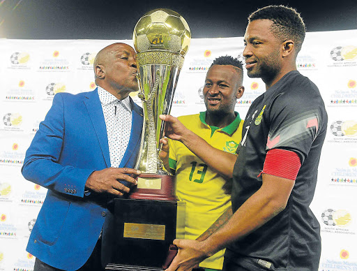 KISS TO BUILD A DREAM ON: From left, SOWETO, SOUTH AFRICA - SEPTEMBER 08: Bafana Bafana coach Shakes Mashaba, Mpho Makola and Itumeleng Khune celebrate after overcoming Senegal during the s during the 2015 Nelson Mandela Challenge match at Orlando Stadium on September 08, 2015 in Soweto on Tuesday evening, South Africa. (Photo by Lefty Shivambu/Picture: GALLO IMAGES