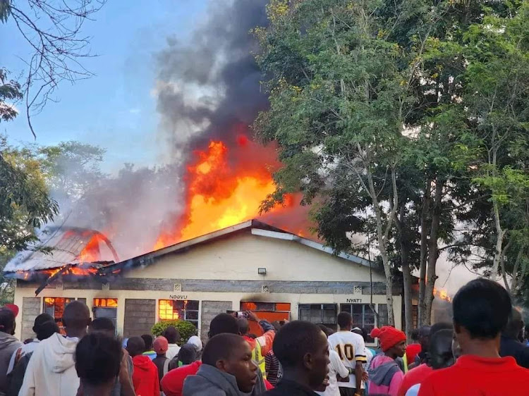 Students watch helplessly as fire gutters down a dormitory at Masii Boys High school in Mwala, Machakos County on April 2, 2024/ HANDOUT