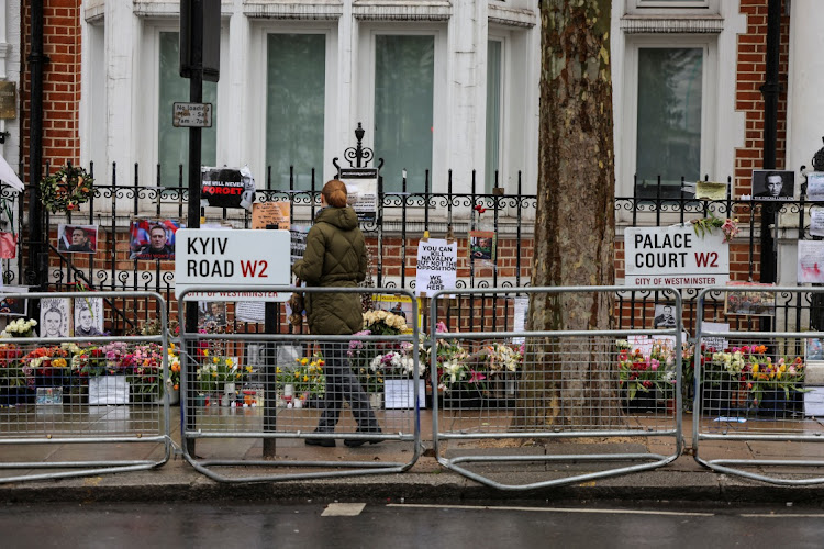 A person looks at flowers for Russian opposition politician Alexei Navalny, on the final day of the presidential election in Russia, opposite the Russian Embassy, in London, Britain, on March 17 2024. Picture: REUTERS/KEVIN COOMBS