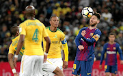 Barcelona's Lionel Messi heads the ball in front  of Wayne Arendse of  Downs during the Nelson Mandela  Challenge at FNB.