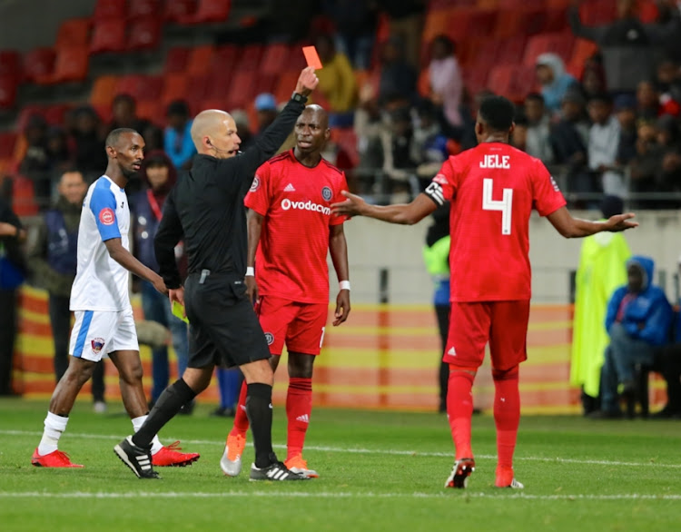 Referee Victor Gomez shows a red card to Orlando Pirates defender Mthokozisi Dube during the Absa Premiership match against Chippa United at Nelson Mandela Bay Stadium on August 08, 2018 in Port Elizabeth, South Africa. Pirates won 1-0.
