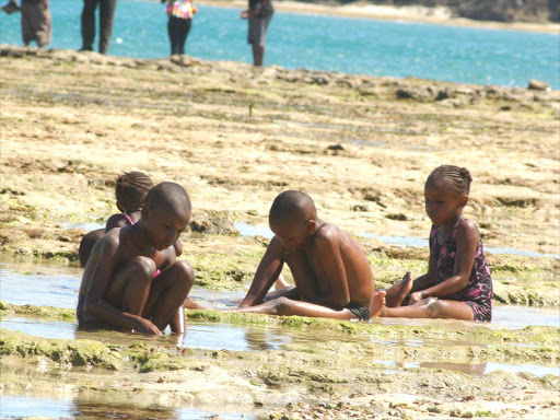 Children playing at a beach in Mombasa.