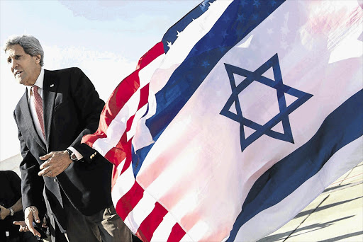 FLYING THE FLAGS: US Secretary of State John Kerry at Ben Gurion International Airport in Tel Aviv, Israel, this week. He has been meeting Israeli and Palestinian leaders in the hope of brokering a peace treaty between them