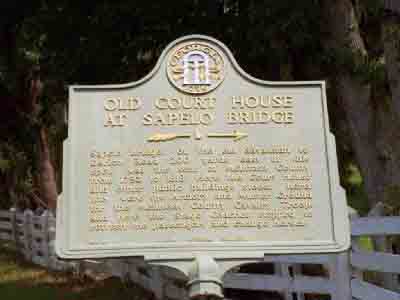 Sapelo Bridge, on the old Savannah to Darien Road 200 yards east of this spot, was the seat of McIntosh County from 1793 to 1818. Here the Court House and other public buildings stood; here, too,...