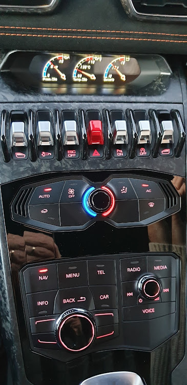 The lower buttons on the command console are from cousin Audi, but the aircraft-style toggles and composite carbon fibre create an exotic Lambo look.