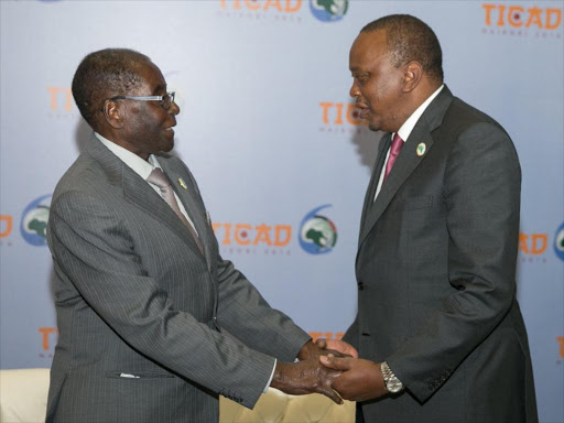 President Uhuru Kenyatta with his Zimbabwe counterpart Robert Mugabe when the two held talks in the sidelines of TICAD VI. /PSCU