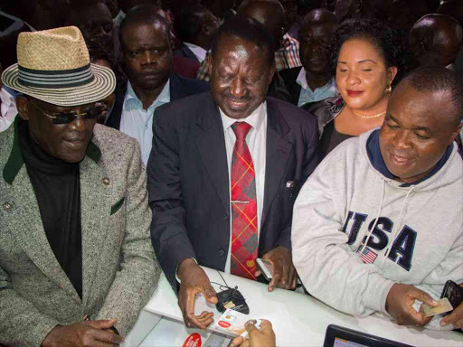 NASA Leader Raila Odinga with Former Machakos Senator Johnstone Muthama and Kiminini MP Chris Wamalwa at the Airtel shops Koinange street receiving his newly purchased Airtel sim card on November 6, 2017