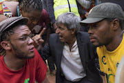 Wits University vice-chancellor Adam Habib in an exchange with a student as Wits EFF chairman Vuyani Pambo, in red, and former SRC president Mcebo Dlamini, in yellow, look on. File photo