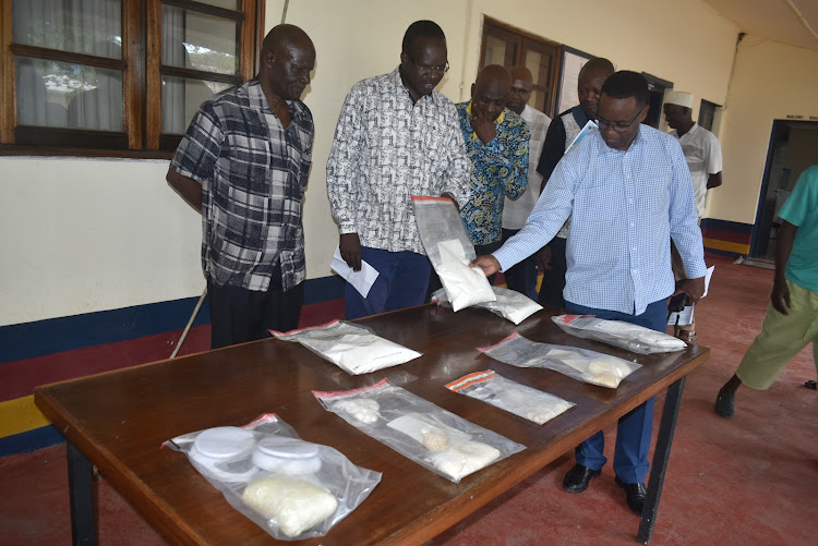 Coast police chiefs inspect sachets of heroin and cocaine at regional police headquarters in Mombasa, on August 25, 2019