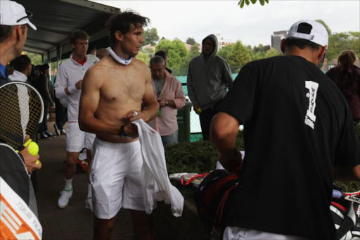 Spanish tennis player Rafael Nadal removes his top after a training session on the Aorangi Practice court at the All England Lawn Tennis and Croquet Club ahead of the Wimbledon Lawn Tennis Championships on June 18, 2011 in London, England. The Championships which are celebrating their 125th anniversary this year begin on June 20, 2011. (Photo by Oli Scarff/Getty Images)