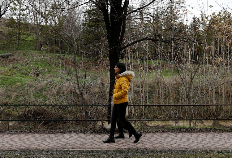 Azam Jangravi and her daughter walk along a park, at the unknown location, February 7, 2019.