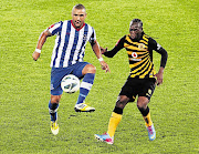 Delron Buckley of Maritzburg United tussles with Chiefs player Reneilwe Letsholonyane during the Absa Premiership match at Peter Mokaba Stadium on Wednesday. Chiefs, who have opened a seven-point gap, take on Golden Arrows tomorrow