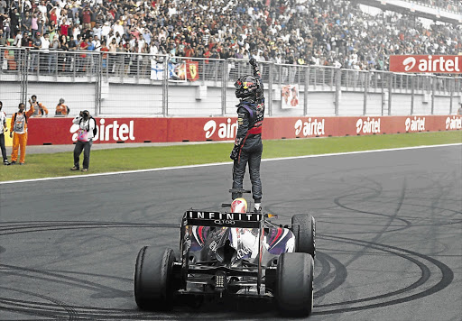 WINNER GETS THE DOUGHNUTS: Sebastian Vettel celebrates after winning the Indian F1 Grand Prix and with it the F1 title at the Buddh International Circuit in Greater Noida yesterday. His team was fined for his celebratory doughnuts.