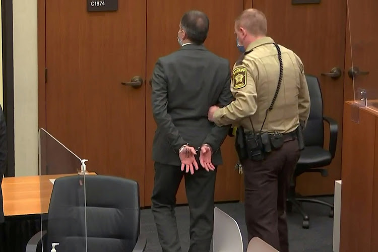 Former Minneapolis police officer Derek Chauvin is led away in handcuffs after a jury found him guilty of all charges in his trial for second-degree murder, third-degree murder and second-degree manslaughter in the death of George Floyd.